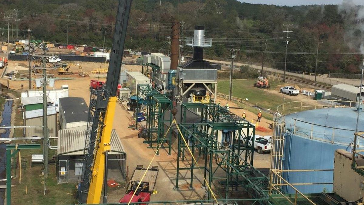 Crane and erected structural steel among process piping inside an operating industrial plant
