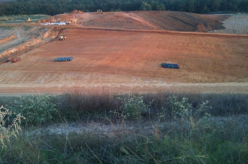 Heavy trucks working a new county landfill cell