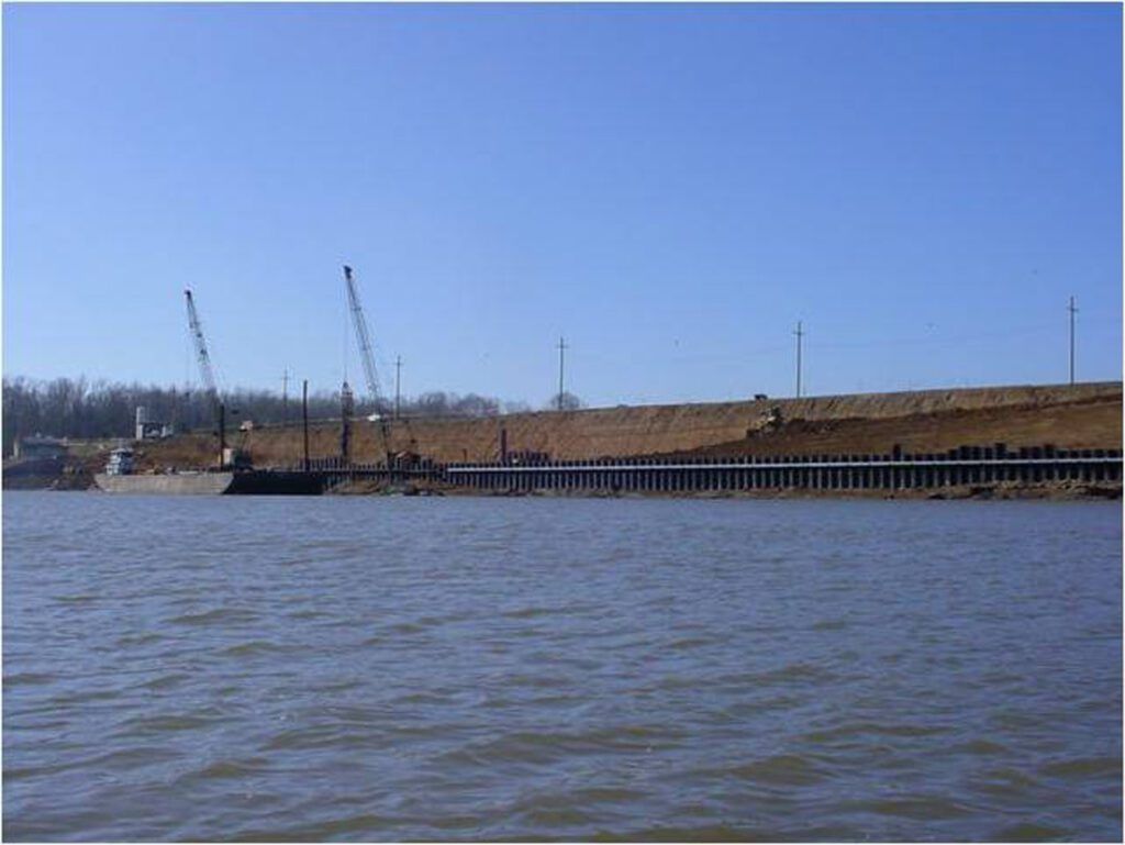Barges and equipment working along a levee during stabilization work