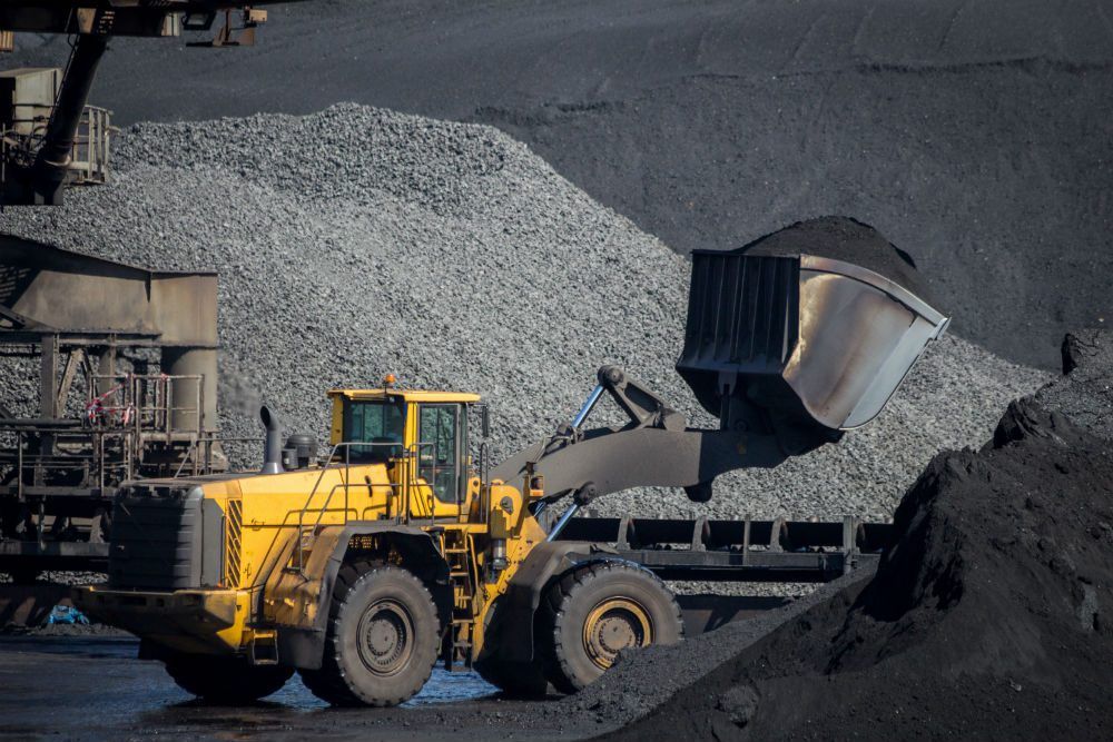 Truck and dump trailer handling material at a plant site