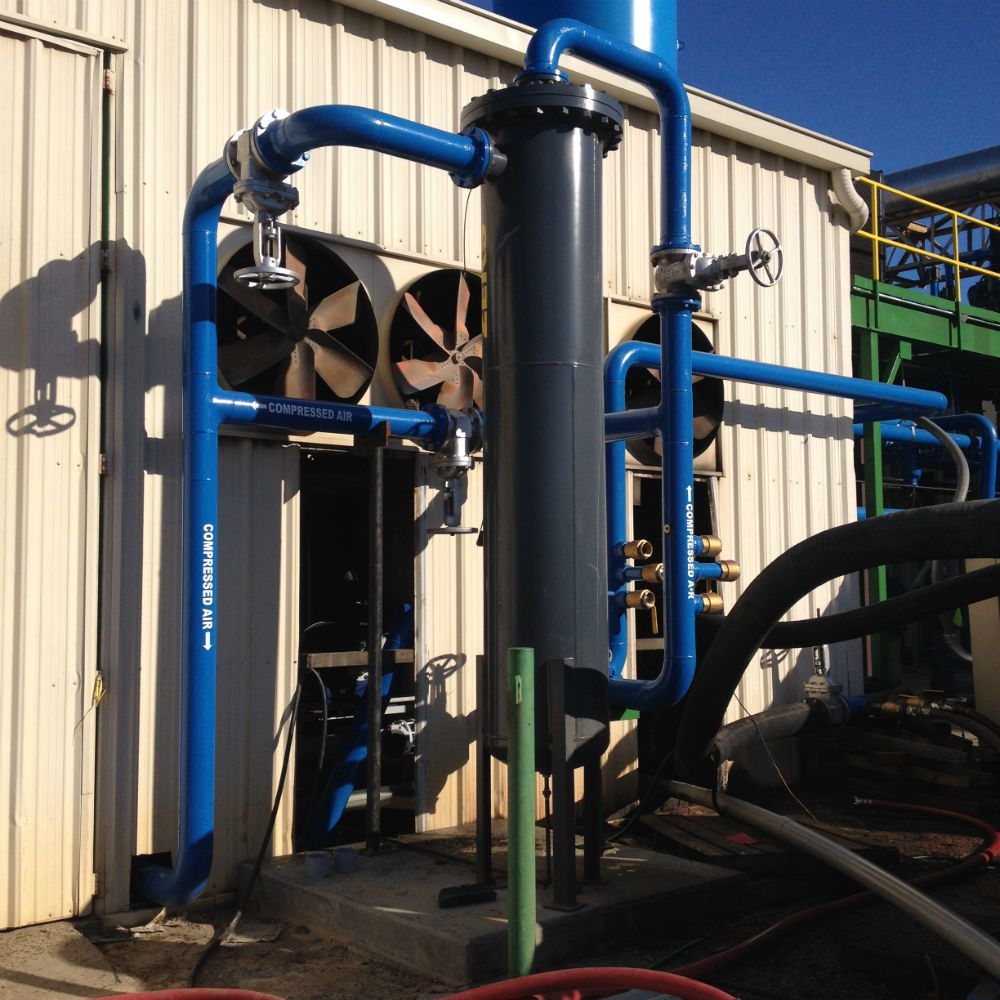 Blue process piping system tied into a plant wall