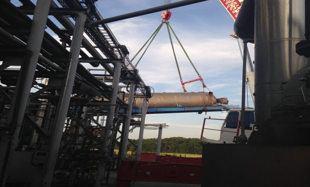 Crane lifting soil dryer equipment during a plant relocation
